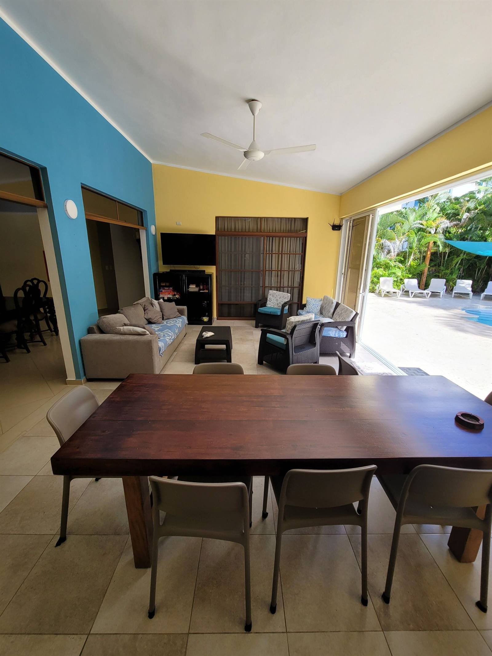 B&B Pavillion: shared living room with a large wooden table, sofas and a TV